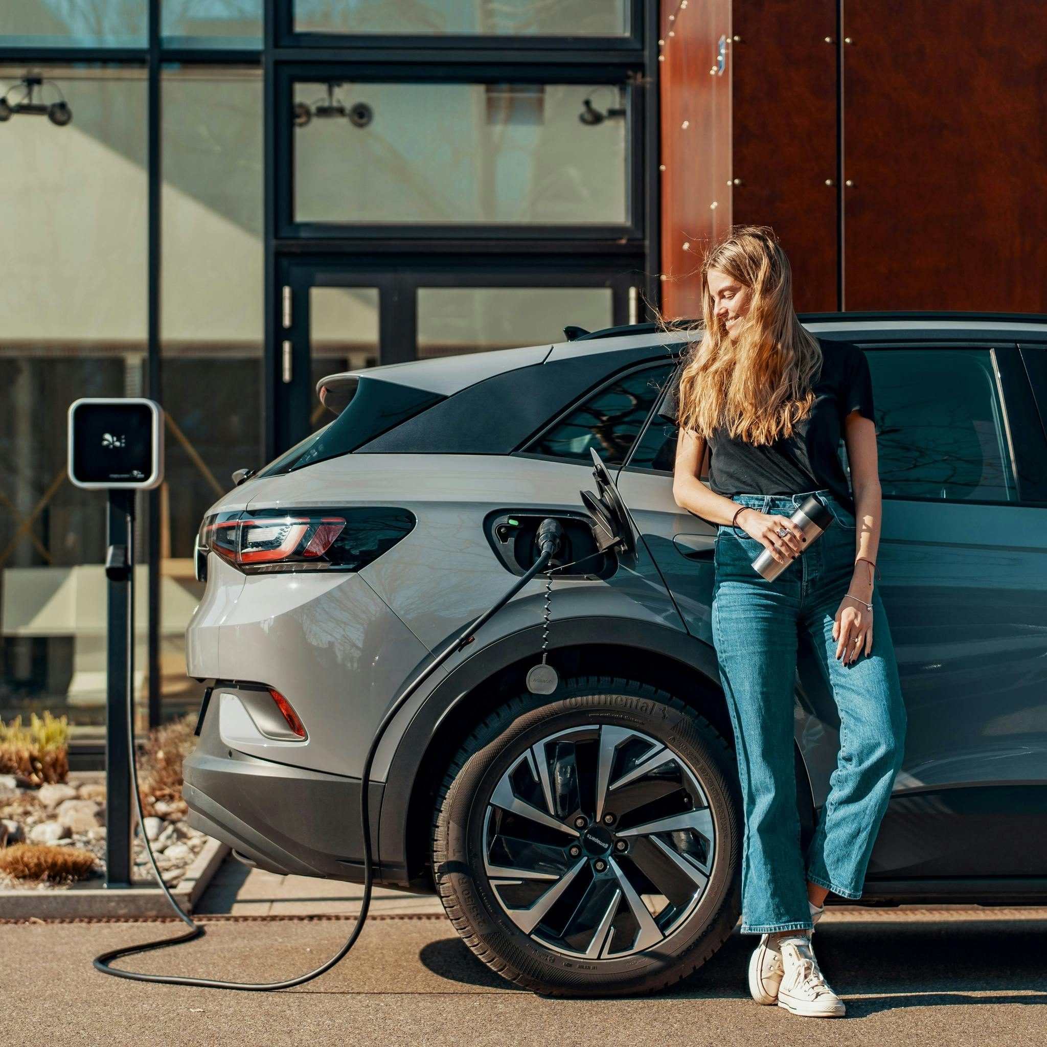 Women charging electric car