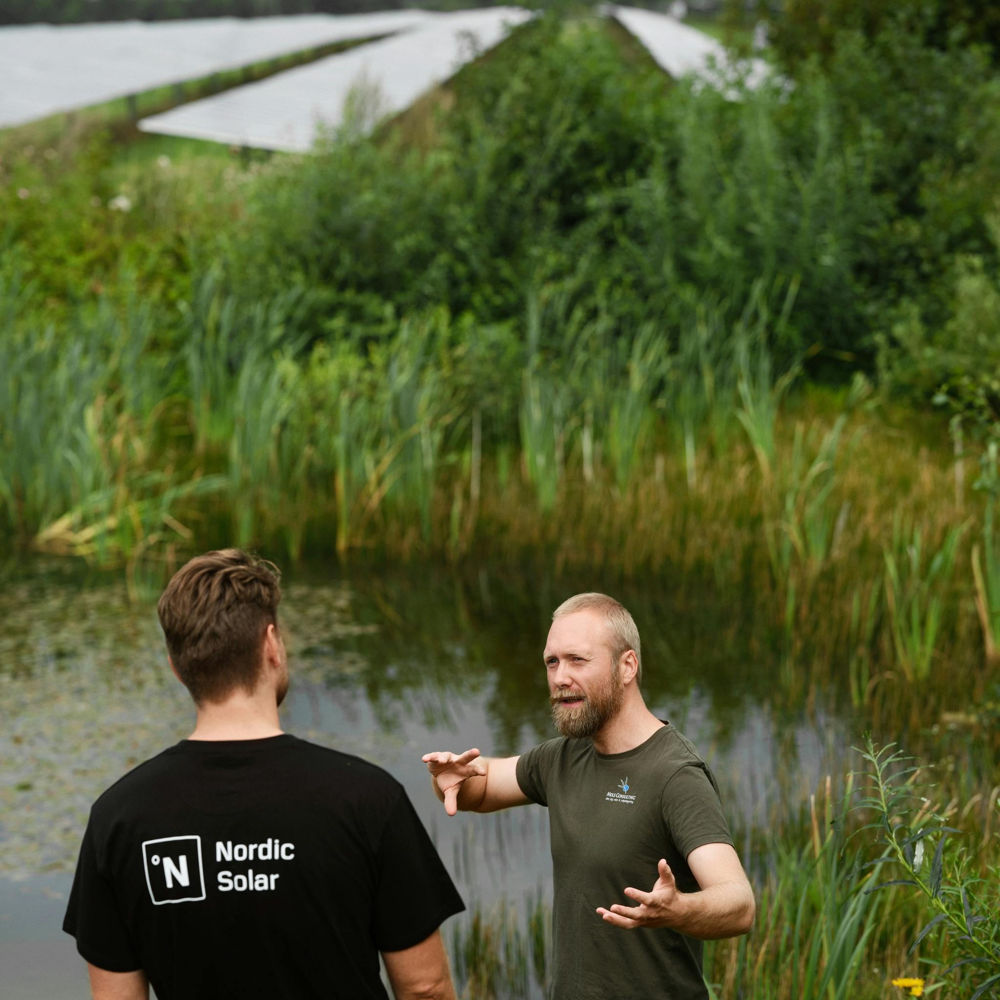 Lasse from Mols Consulting by pond in solar park