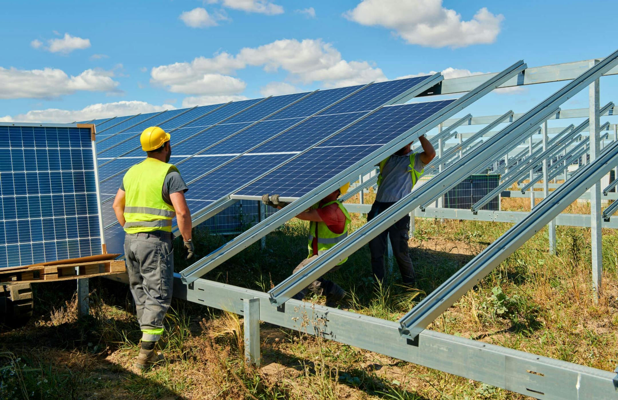Men setting up solar panels