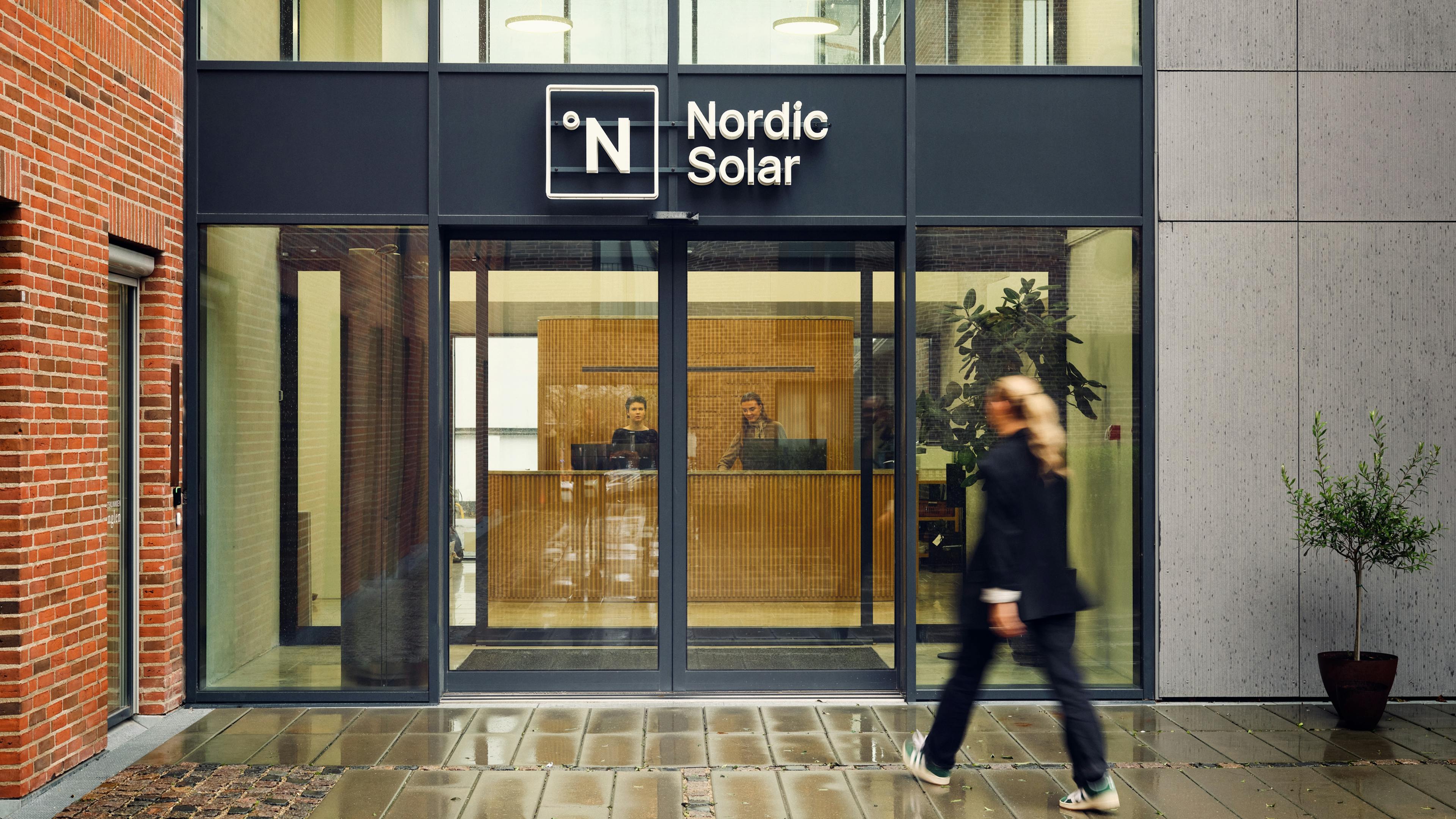 Girl walking through doors at Nordic Solar
