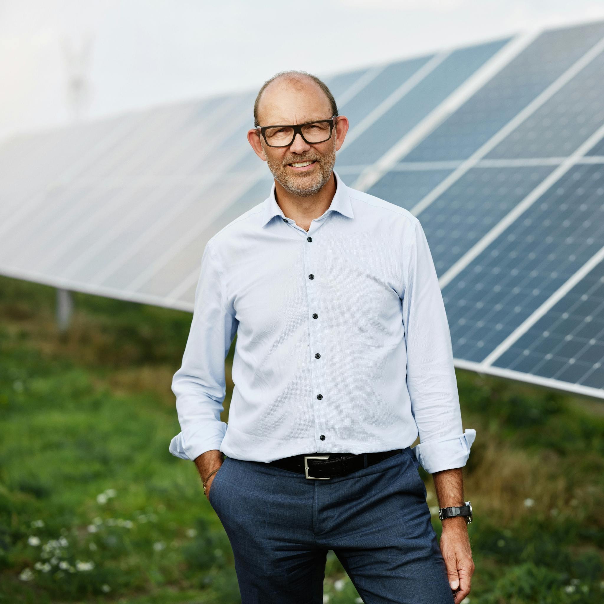 CEO in front of solar panels